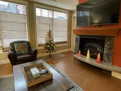 a living room with a christmas tree and a fireplace at Luxury Resort 2Bedroom 2Bath Sleeps 6 945 square feet in Canmore