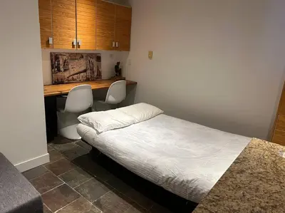 a bedroom with a bed and a desk with two chairs at Family, Pet Friendly Sechelt Waterfront Home, Beach Access, Sleeps 14 in Sechelt