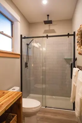 a bathroom with a shower and a toilet at Cowichan Valley Guest Cottage in Ladysmith