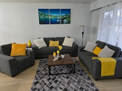 a living room with two couches and a coffee table at 3 Bedroom Home away from Home in Calgary
