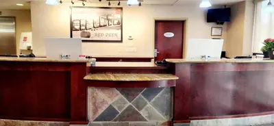 a bar in a restaurant with a lobby at Park Hill Inn & Suite in Red Deer
