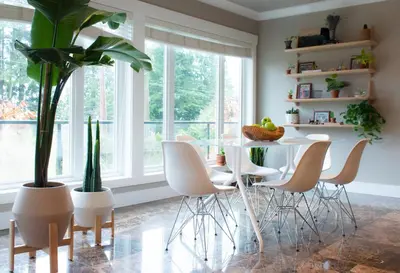 a dining room with a table and chairs and plants at Welcome Home in North Vancouver
