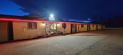 a building with a light on it at night at GRIZZLY MOTEL in Swan Hills