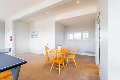 a kitchen and dining room with a table and chairs at Lakeview 2-bed 2-bath Entire Suite near Summerhill Winery in Kelowna