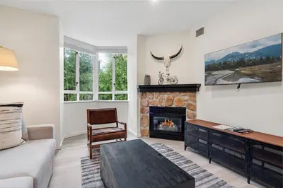 a living room with a fireplace and a couch at Cascade Lodge in Whistler
