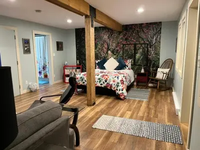 a bedroom with a bed and a couch in a room at Cottonwood#2 in Youbou