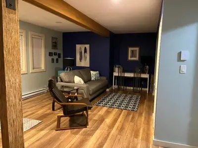 a living room with a couch and a chair at Cottonwood#2 in Youbou