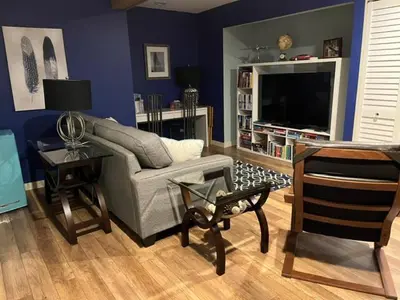 a living room with a couch and a tv at Cottonwood#2 in Youbou