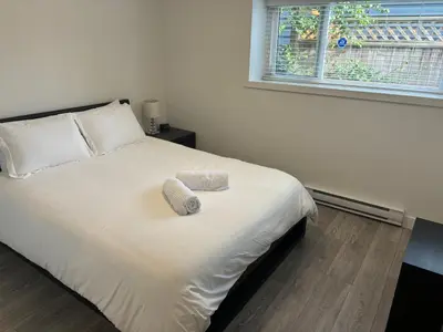 a bedroom with a bed with two towels on it at Large 2 bedroom private suite ! in North Vancouver