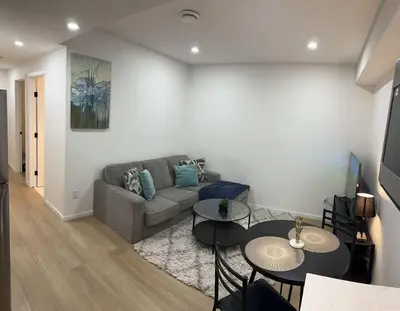 a living room with a couch and two tables at Guest suite in Southwest Calgary in Calgary