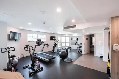 a gym with bikes and exercise equipment in a room at Le Chamois by Outpost Whistler in Whistler