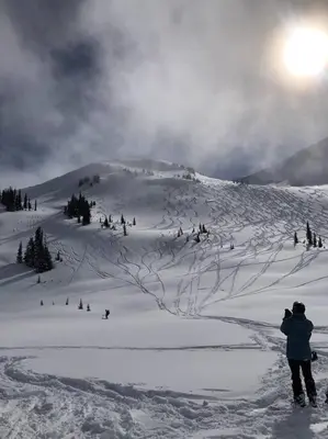 a person is standing on a snow covered mountain at Ski nest 5m to Creekside Gondola in Whistler