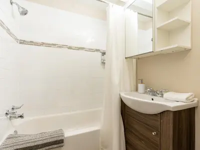 a bathroom with a sink and a tub and a toilet at Ski nest 5m to Creekside Gondola in Whistler