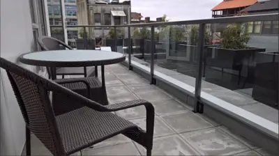 a patio with a table and chairs on a balcony at Cityzen Sanctuary in Victoria