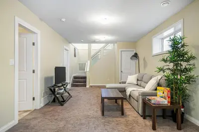a living room with a couch and a table at 5 Bedroom House in McConachie, Near Anthony Henday, Sleeps 12, Backyard, Netflix, Free Parking in Edmonton