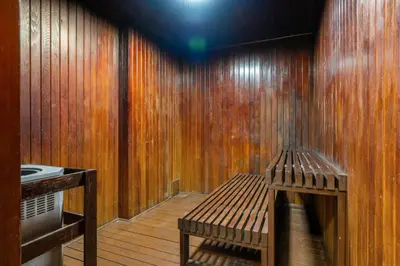 a room with a wooden wall with a bench at Prime Location Near Jasper Ave with Downtown Views, Netflix, Gym, Sauna, Sleeps 4 in Edmonton