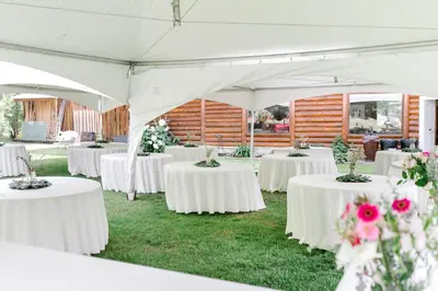 a group of tables in a tent with flowers at Anglemont Inn in Anglemont