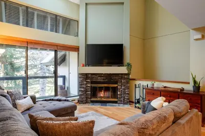 a living room with a couch and a fireplace at 3BR in Wintergreen, Family Sized, Wood Burning Fireplace, Secure Parking, Ski Hill Bus Access in Whistler