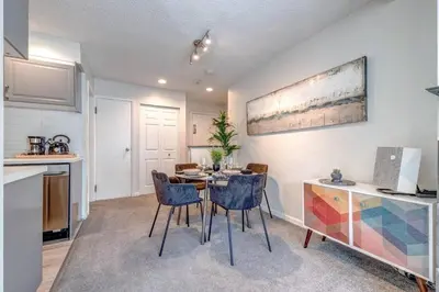 a kitchen and dining room with a table and chairs at 1Bd Unit In the heart of Whistler Village in Whistler
