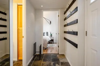 a hallway with a room with a bed and a mirror at 1BR plus Loft in Gondola Village, Creekside, Amazing Patio with Views, Near Gondola, Free Parking in Whistler