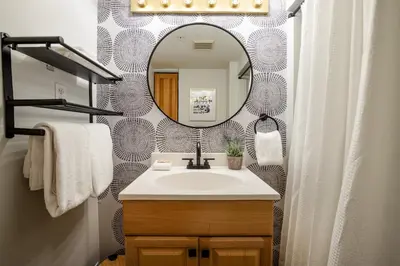a bathroom with a sink and a mirror at 1BR plus Loft in Gondola Village, Creekside, Amazing Patio with Views, Near Gondola, Free Parking in Whistler