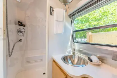 a bathroom with a sink and a shower at John Henry's Marina and Resort in Garden Bay