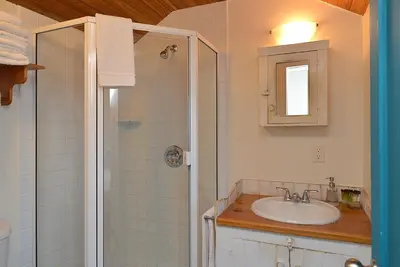 a bathroom with a sink and a shower at John Henry's Marina and Resort in Garden Bay