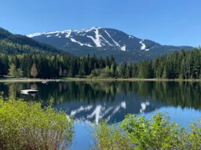 a view of a lake with a snow covered mountain at Cozy Townhouse in Whistler Village North in Whistler
