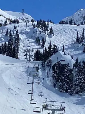 a group of people on a ski lift in the snow at Cozy Townhouse in Whistler Village North in Whistler