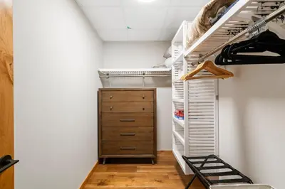 a room with a closet with a wooden dresser at Timberstone Condo by Canadian Rockies Vacation Rentals in Canmore