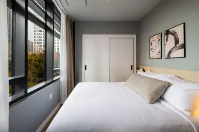 a bedroom with a white bed and a window at Smithe House in Vancouver