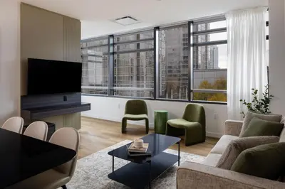 a living room with a couch and a tv at Smithe House in Vancouver