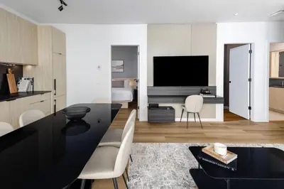a kitchen and living room with a black table at Smithe House in Vancouver