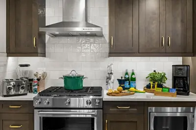 a kitchen with a stove with a pot on it at New Spacious Mountain View Condo in Canmore With Hot Tub, Park Pass, Prime Location in Canmore