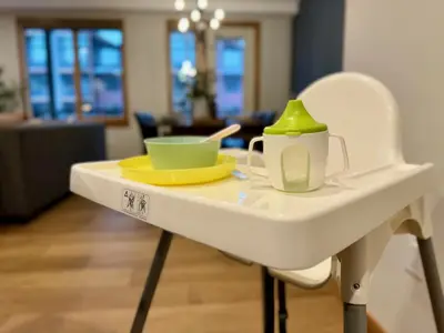 a white table with a cup and a tea pot on it at New Spacious Mountain View Condo in Canmore With Hot Tub, Park Pass, Prime Location in Canmore