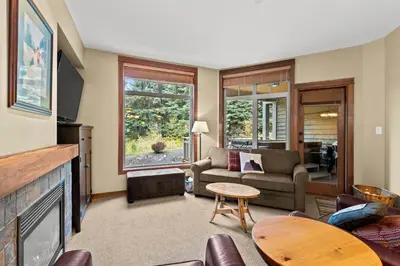 a living room with a couch and a fireplace at Settlers Crossing #35 condo in Sun Peaks