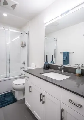 a white bathroom with a sink and a toilet at L'Austin Rêve by Revelstoke Vacations in Revelstoke