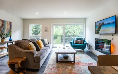 a living room with a couch and a table at L'Austin Rêve by Revelstoke Vacations in Revelstoke
