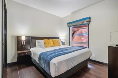 a bedroom with a bed and a window at Cozy One Bedroom Condo with Indoor Pool and HotTub in Canmore