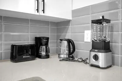 a kitchen counter with various appliances on a counter top at Modern & Spacious Guest Suite in Calgary