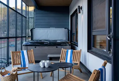a patio with a stove and a table and chairs at Drop in Condo by Revelstoke Vacations in Revelstoke