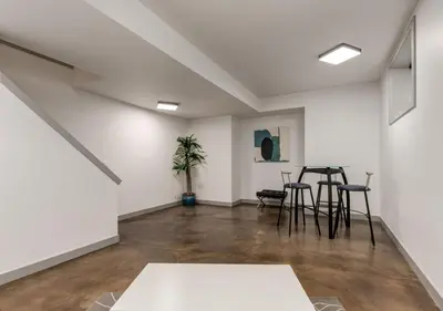 a room with white walls and tables and chairs at Newly Renovated Vacation Home w/ Hot Tub & Garage in Calgary
