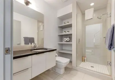 a bathroom with a toilet and a sink and a shower at Newly Renovated Vacation Home w/ Hot Tub & Garage in Calgary