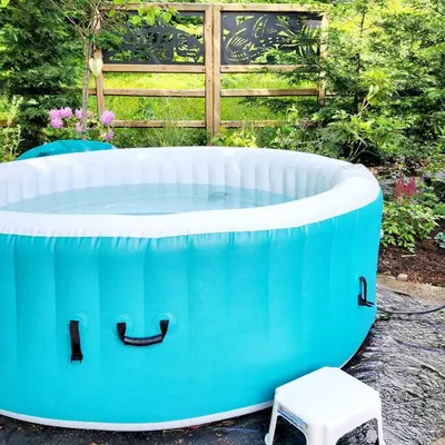 a blue and white bath tub with a stool at Tiny House with Hot Tub, close to golf and skiing!! in Oyster Bay
