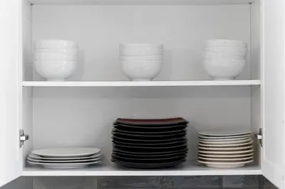 a cabinet filled with plates and bowls and dishes at Modern Luxury Home - King Bed•Arcade•WEM•A/C in Edmonton