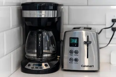 a coffee maker and a blender on a counter at Family Home Retreat - 9 mins to WEM - Vintage Arcade-Ping Pong -Air Conditioning in Edmonton