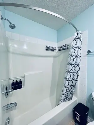 a bathroom with a white tub and a sink at Modern Upper Level Duplex House in Slave Lake