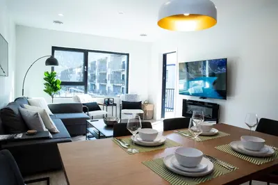 a living room with a table and chairs and a couch at Birdies and Bears by Revelstoke Vacations in Revelstoke