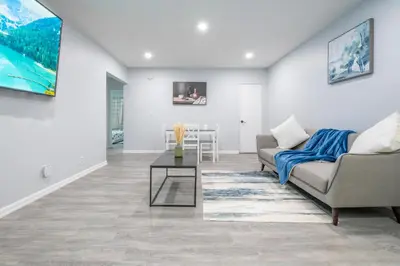 a living room with a couch and a table at Centre Street 2bed Upper Suite - 4408 in Calgary