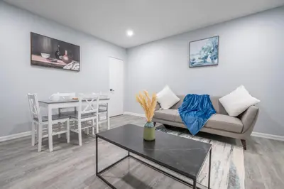 a living room with a couch and a table at Centre Street 2bed Upper Suite - 4408 in Calgary